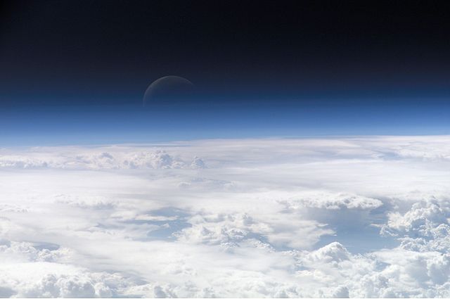 View of the crescent moon through the top of the Earth's atmosphere. Photographed above 21.5°N, 113.3°E by International Space Station crew Expedition 13 over the South China Sea, just south of Macau (NASA image ID: ISS013-E-54329). NASA Earth Observatory